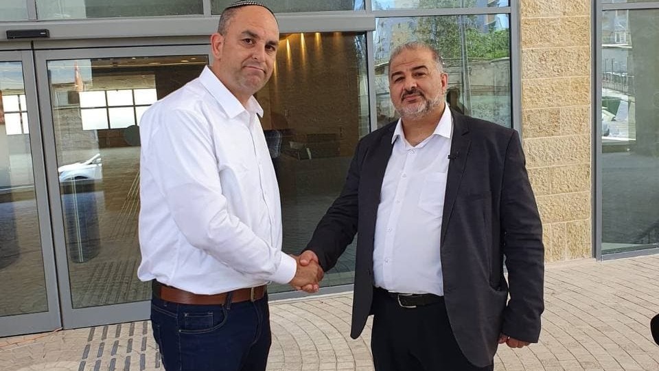 Lod Mayor Yair Revivo and Ra'am Chairman Mansour Abbas shake hands during the parliament member's visit to the mixed central city
(Photo: Moshe Eldan) מנסור עבאס ויאיר רביבו