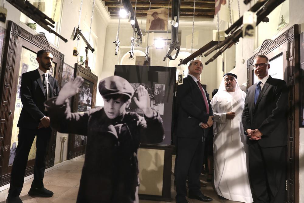 Israeli's Ambassador to the United Arab Emirates, Eitan Na'eh, third right, Ahmed Al Mansuri, founder of Crossroads of Civilization private museum, second right, and German Amabassador in UAE, Peter Fischer, right, visit an exhibition commemorating the Jewish Holocaust in Dubai 