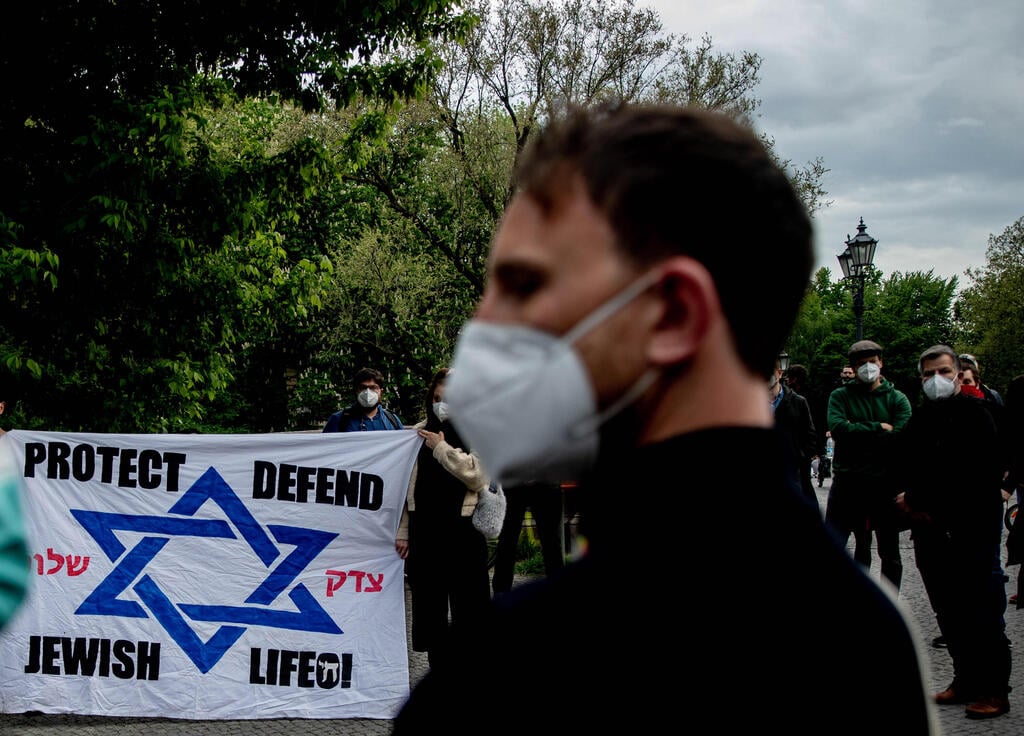 Participants at a vigil against anti-Semitism gather in front of the a synagogue in Berlin, May 16, 2021 