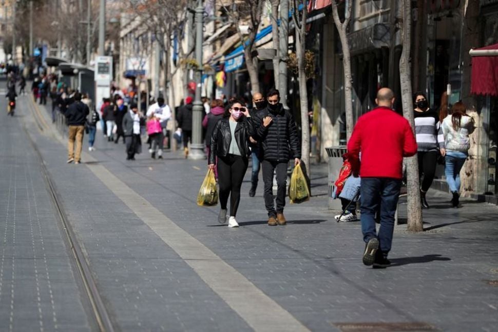 People carry shopping bags in Jerusalem (Photo: Reuters) People carry shopping bags as Israel reopens swathes of its economy, while it continues to lift restrictions of a national lockdown to fight the coronavirus disease (COVID-19), in Jerusalem
