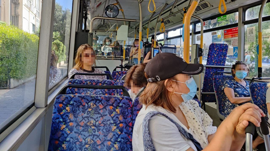  Israelis wearing masks on a bus 