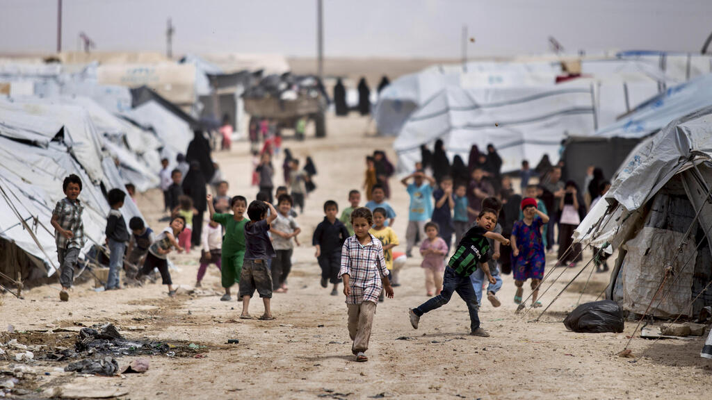 Children gather outside their tents, at al-Hol camp, which houses families of members of the Islamic State group, in Hasakeh province, Syria, Saturday, May 1, 2021