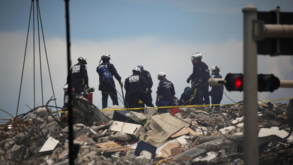 Rescue teams at the site of the collapsed condominium 