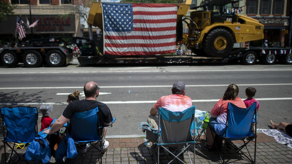 People sit in chairs to observe a 4th of July parade on July 4, 2021 in Pottstown, Pennsylvania
