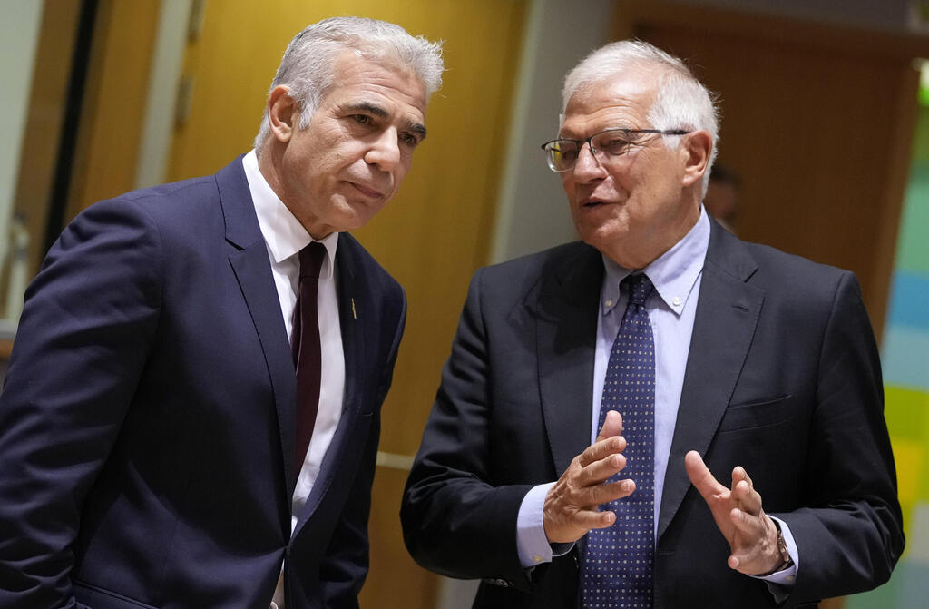 Foreign Minister Yair Lapid, left, speaks with European Union foreign policy chief Josep Borrell 