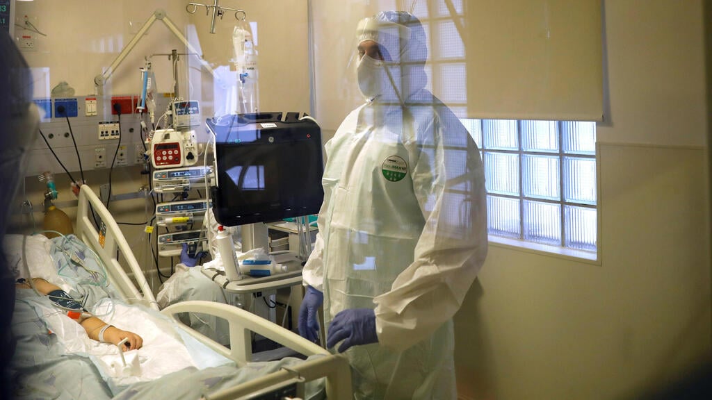 Hospital staff provide medical care for patients at a coronavirus disease (COVID-19) ward amid a surge in new cases 