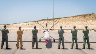 Drone pilots from five countries and Israel pose in front of a Hermes-450 