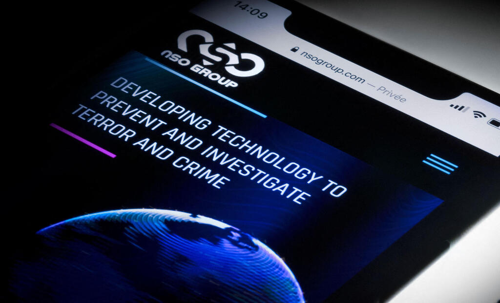 This studio photographic illustration shows a smartphone with the website of Israel's NSO Group which features 'Pegasus' spyware, on display in Paris on July 21, 2021 