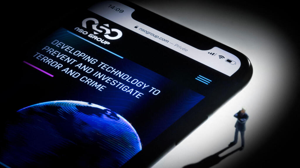 This studio photographic illustration shows a smartphone with the website of Israel's NSO Group which features 'Pegasus' spyware, on display in Paris on July 21, 2021 