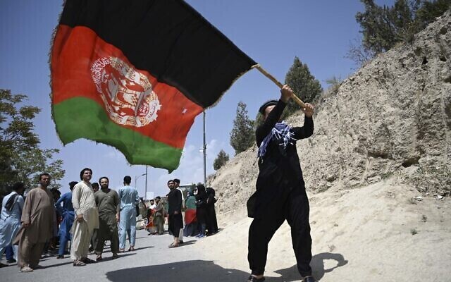 An Afghan waves the national flag in Kabul 