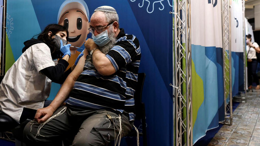 A man receives his third dose of the coronavirus disease (COVID-19) vaccine in Jerusalem, August 15, 2021 