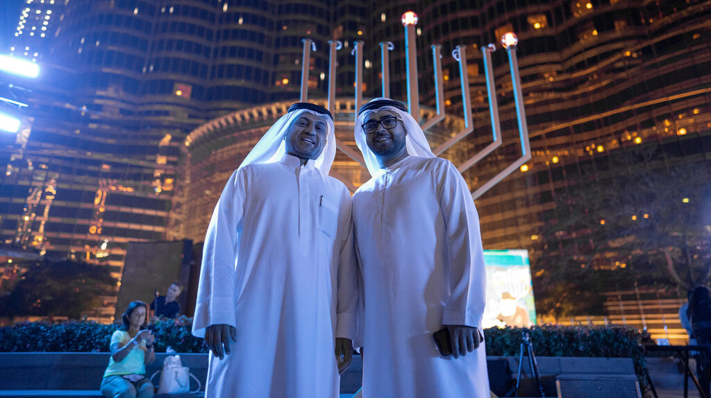 Two local residents of the UAE stand in front of a Hanukah Menorah in Dubai last December 