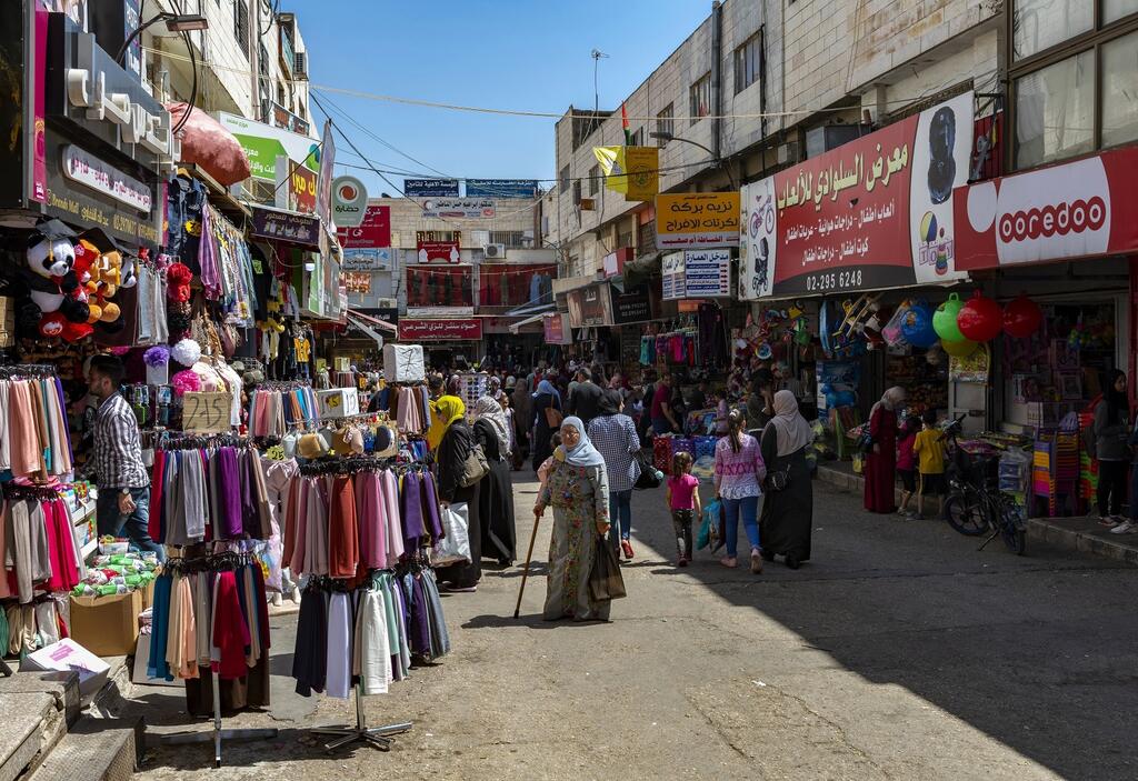Shoppers on the streets of the West Bank city of Ramallah last year 