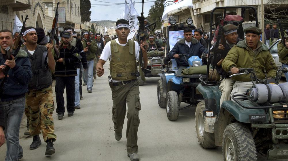  Zakaria Zubeidi, center, then local leader of the Al Aqsa Martyrs Brigades and other militants march in the West Bank town of Jenin during a rally to mark the third anniversary of the assault by the Israeli army on the Jenin refugee camp 