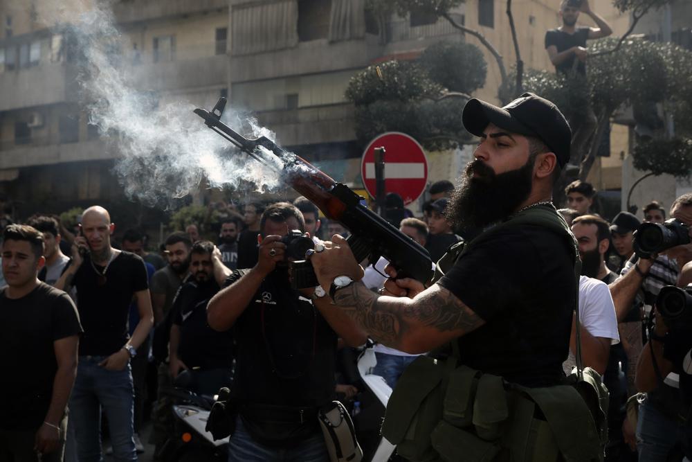 A supporter of the Shi'ite Amal group fires in the air during the funeral processions of Hassan Jamil Nehmeh, who was killed during Thursday clashes, in the southern Beirut suburb of Dahiyeh, Lebanon (Photo: AP) A supporter of the Shiite Amal group fires in the air during the funeral processions of Hassan Jamil Nehmeh, who was killed during Thursday clashes, in the southern Beirut suburb of Dahiyeh, Lebanon