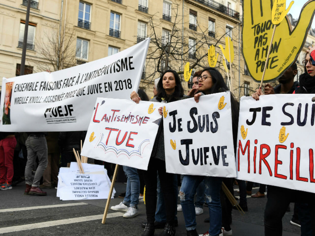 Politicians and others stand behind banners as they prepare to take part in a silent march in Paris on March 28, 2018 in memory of Mireille Knoll 
