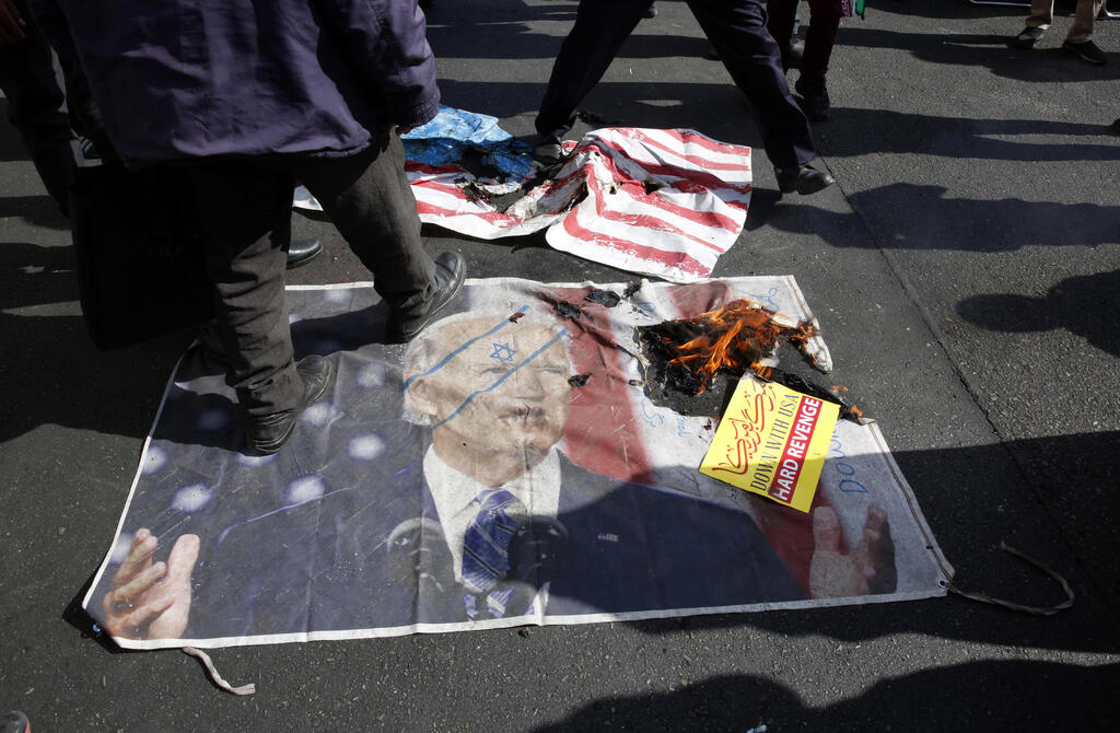 People trample on a picture of US president Biden during an anti-US demonstration marking the 42nd anniversary of US Embassy takeover, in front of the former US embassy in Tehran, Iran 