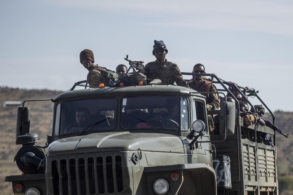 Ethiopian government soldiers ride in the back of a truck on a road near Agula, north of Mekele, in the Tigray region of northern Ethiopia 
