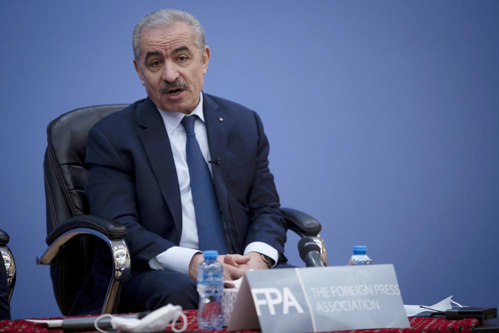 Palestinian Prime Minister Mohammad Shtayyeh, right, holds a briefing with members of the Foreign Press Association (FPA), in the West Bank city of Ramallah 