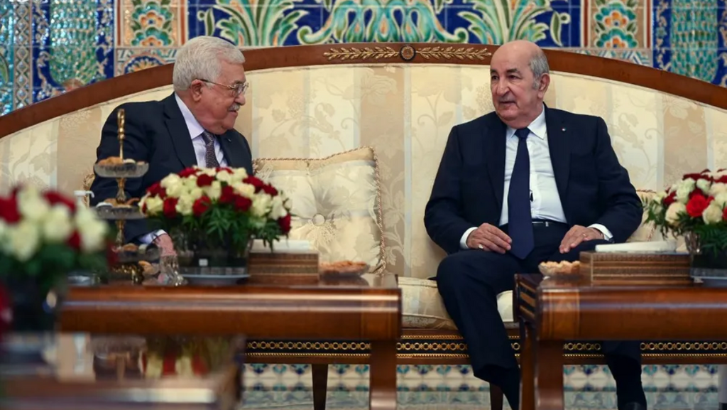 A handout picture provided by the Palestinian Authority's press office on December 5, 2021, shows Algeria's President Abdelmadjid Tebboune (R) and Palestinian leader Mahmoud Abbas in Algiers, Algeria