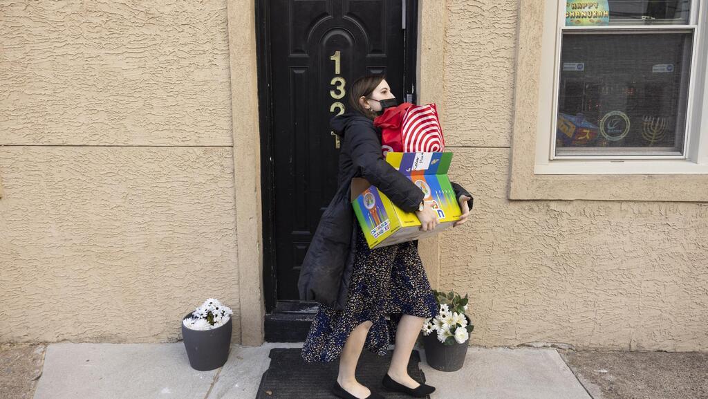 Rabbanit Dasi Fruchter, of the South Philadelphia Shtiebel, carries supplies for a public Hanukkah celebration