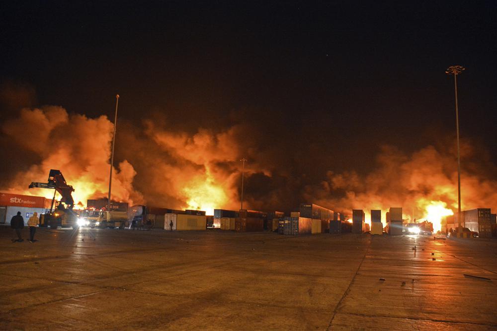flames and smoke rise from burning containers at the scene of a missile attack, at the seaport of the coastal city of Latakia, Syria 