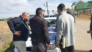 מארגנים מביטים במפה ליד ציון הקבר