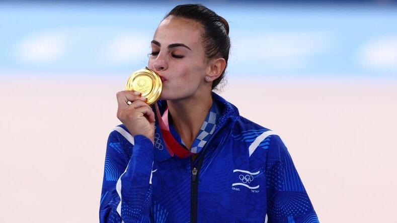 Ashram kisses her gold medal won in the 2020 Tokyo Olympics 