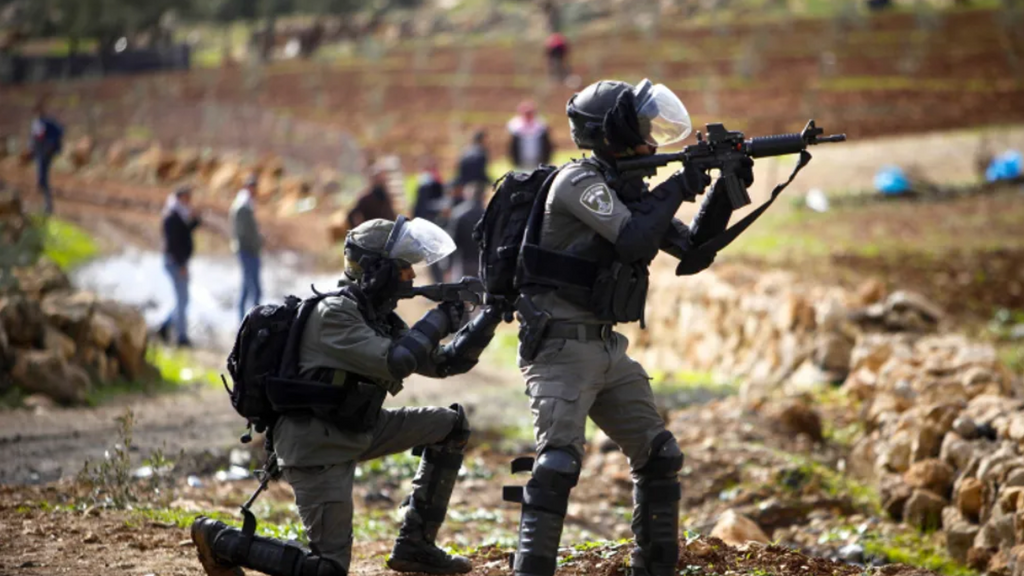 Israeli security forces clash with Palestinians during a protest in the village of Beit Dajan, near the West Bank city of Nablus, December 24, 2021