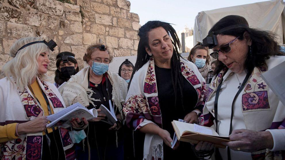 Members of Women of the Wall gather around a Torah scroll the group smuggled in for their Rosh Hodesh prayers marking the new month, at the Western Wall 