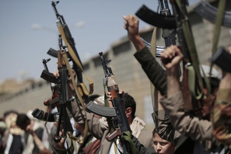 Tribesmen loyal to the Houthi rebels hold their weapons during a rally in Yemen's capital Sanaa 