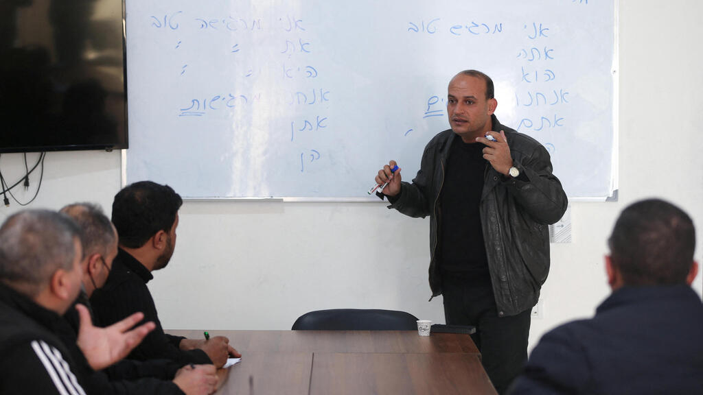A Palestinian teacher teaches Hebrew language to a group of students at Nafha Language Center, in Khan Younis in the southern Gaza Strip 