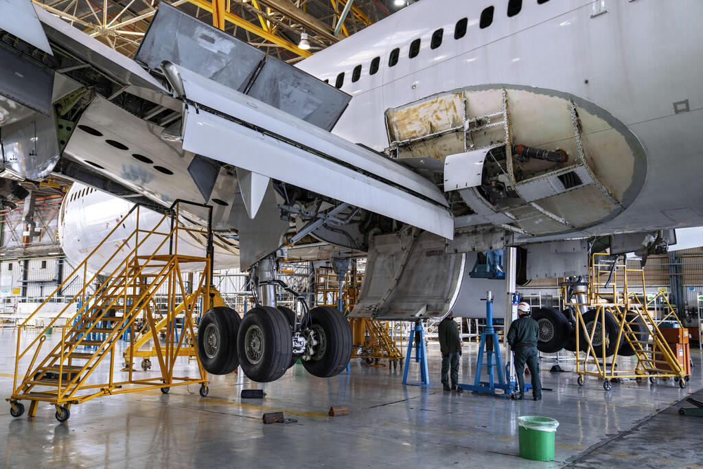 Engineers work on the conversion of a Boeing 767 passenger plane to a cargo plane 