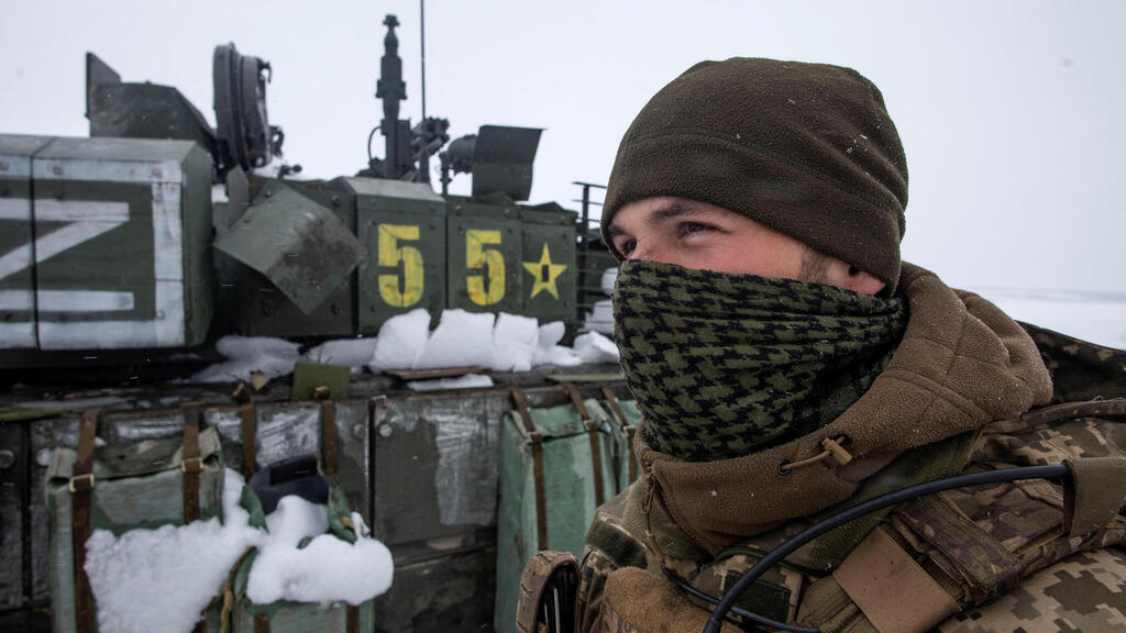 חייל אוקראיני ליד כלי רכב של צבא רוסיה שנפתסו באזור חרקוב