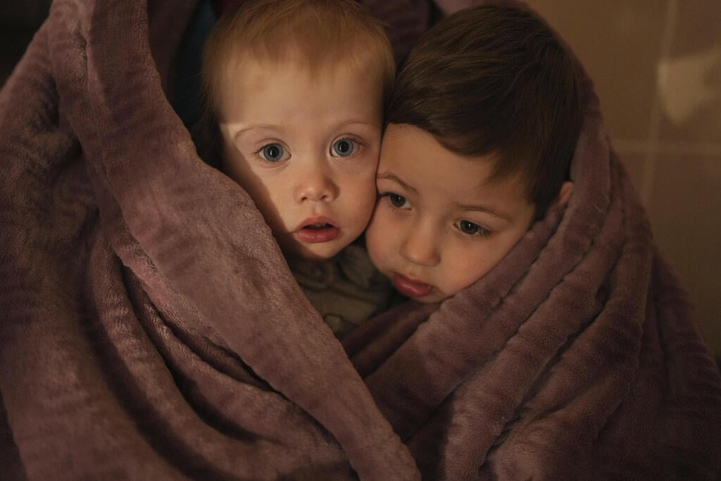 Children in Mariupol hospital attempt to stay warm as city comes under Russian shelling 