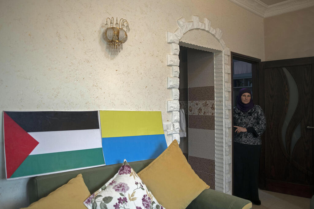  Oksana al-Astal  in her Khan Younis home with Palestinian and Ukraine flags 