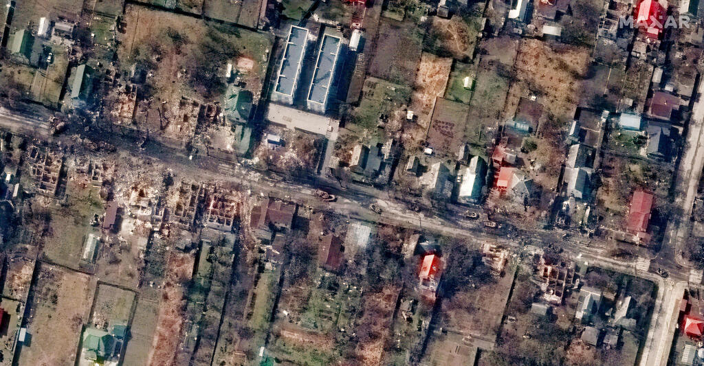 This handout satellite image released by Maxar Technologies on April 4, 2022 shows destroyed homes and vehicles on Vokzalna Street in Bucha 