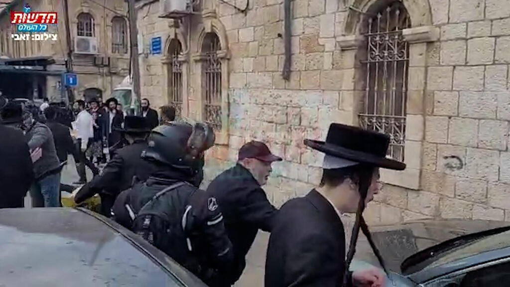 חרדים קיצוניים מנסים לתקוף את דרעי מחוץ לבית הכנסת בירושלים (צילום: זאבי וידבסקי - חדשות כל העולם) תיעוד: חרדים תוקפים את אריה דרעי על רקע שיתוף הפעולה שלו עם מדינת ישראל