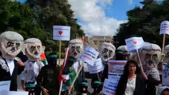 Israel Defense Forces reservists protest outside the UN Human Rights Council in Geneva dressed as Hamas terrorists 