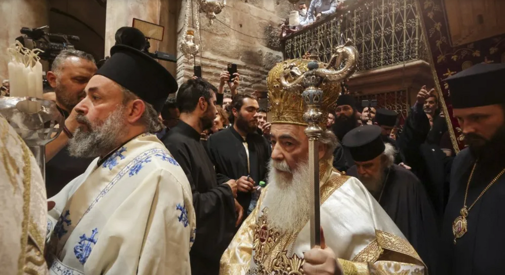 Greek Orthodox Patriarch of Jerusalem Theophilos III leads the procession as worshippers gather in the Church of the Holy Sepulcher in Jerusalem’s Old City on April 23, 2022