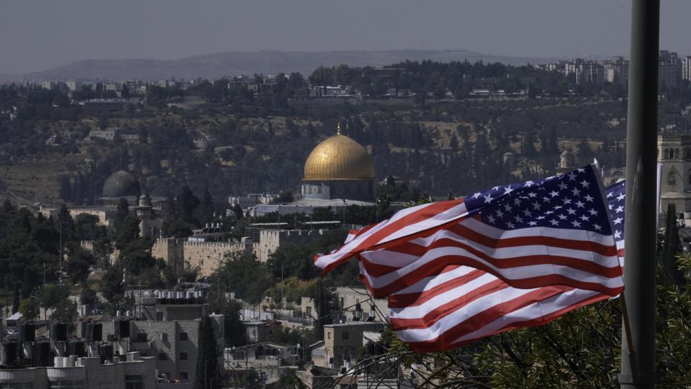 With the Dome of the Rock shrine in the background, U.S. flags fly ahead of a visit by President Joe Biden 