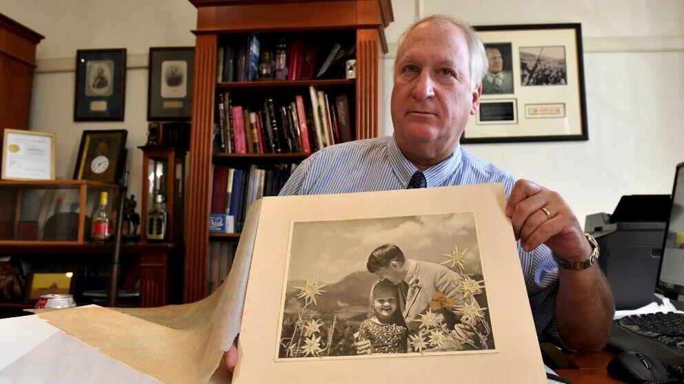 Bill Panagopulos, president of Alexander Historical Auctions LLC in Chesapeake City, Md., with a 1933 Heinrich Hoffmann photograph of Adolf Hitler that sold for $11,520 in 2018