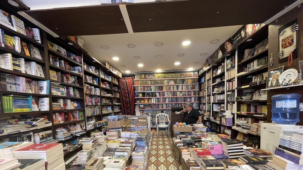Khalid Khandakji waits for customers at The Popular Bookstore, in the Old City of Nablus 