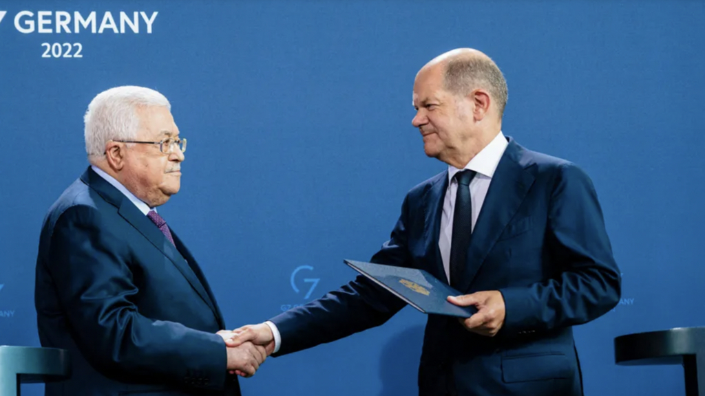German Chancellor Olaf Scholz and Palestinian Authority President Mahmoud Abbas shake hands during a press conference, in Berlin, Germany