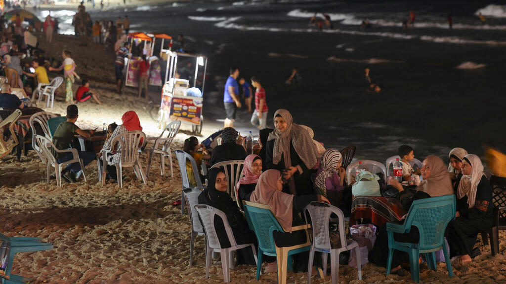 Palestinian women sit at a beach coffee shop in Gaza city, on July 2, 2022