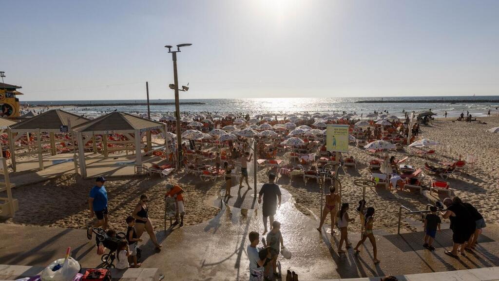 היום עדיין חם, בחג הטמפרטורות רגילות לעונה (צילום: טל שחר) מתרחצים בחוף היום בתל אביב
