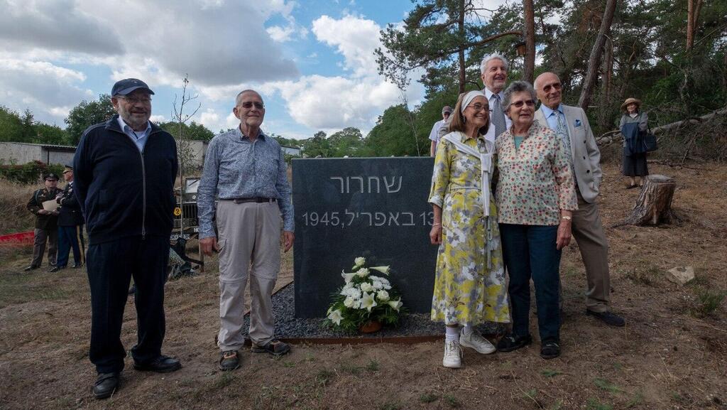 הניצולים לצד האנדרטה