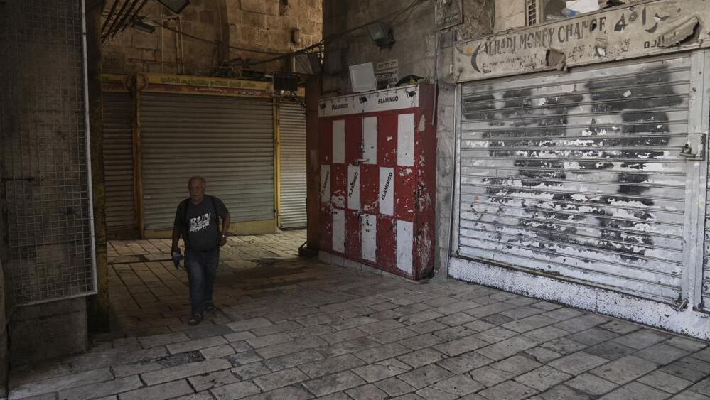 A man walks past shuttered shops in Jerusalem's Old City (Photo: Associated Press) A man walks past shuttered shops in Jerusalem's Old City