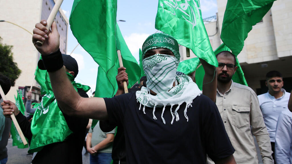 Palestinian demonstrators loyal to the Islamic movement of Hamas march during a protest in the West Bank city of Hebron