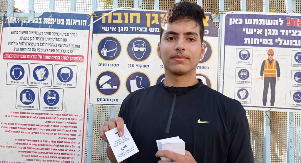 Niji Abu Shehadeh holds a Balad voting slip outside a polling station in Jaffa, Nov. 1, 2022 